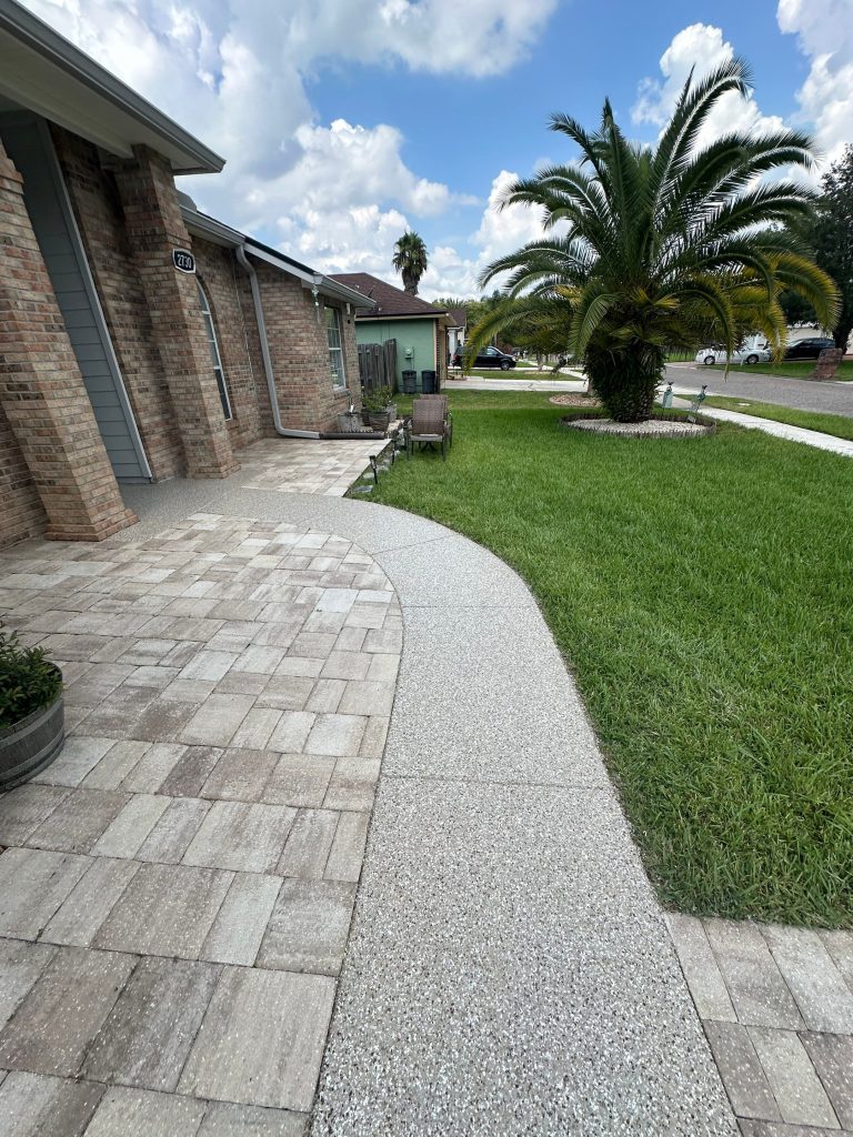 Light gray concrete walkway leading to the home's front entrance