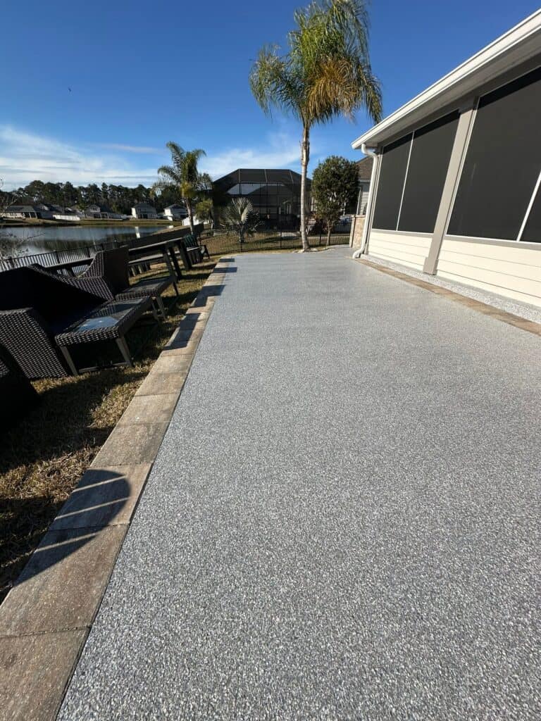 Light gray concrete coating on an outdoor patio overlooking the lake