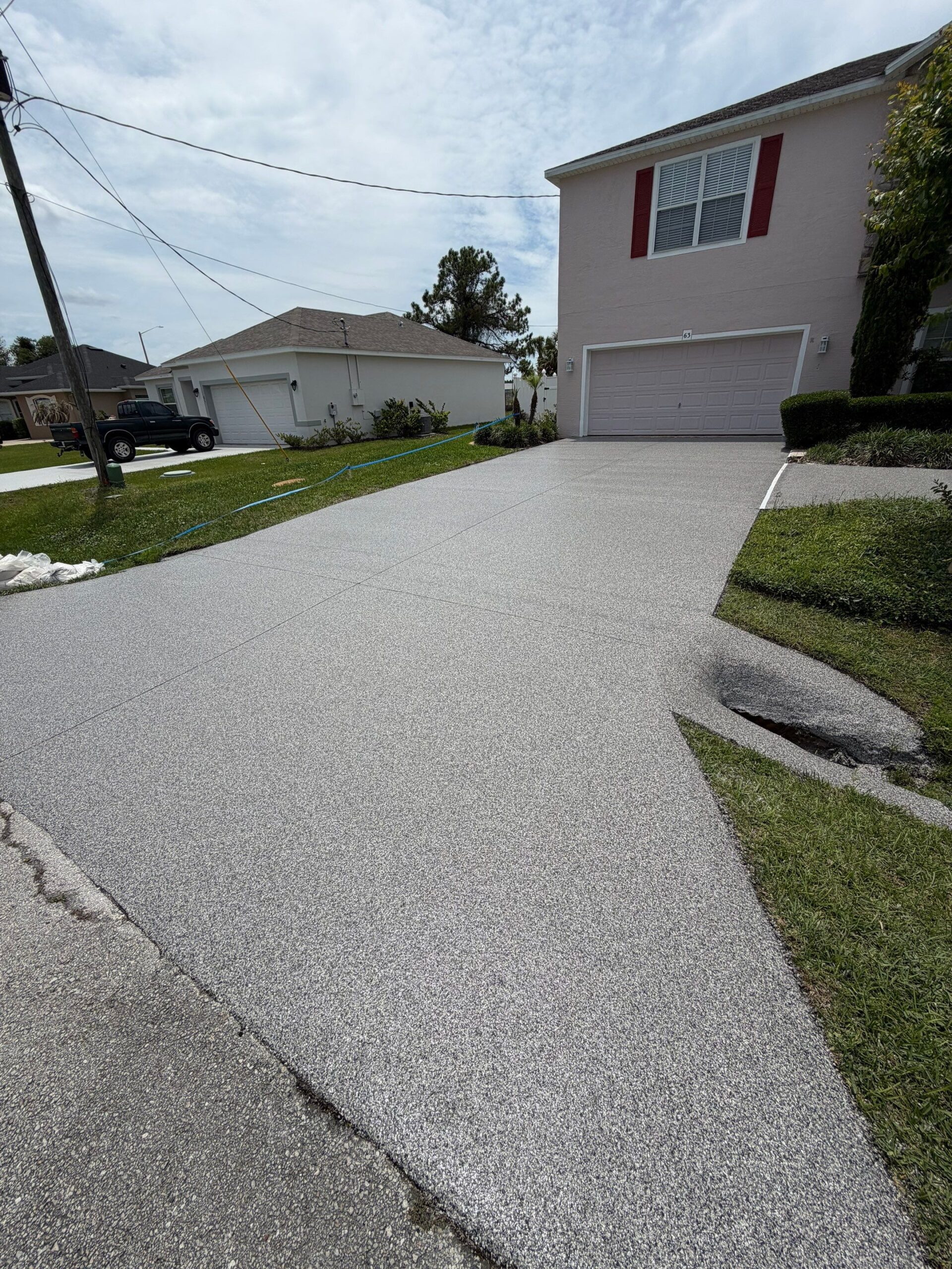 Coated concrete driveway from the garage looking toward the street
