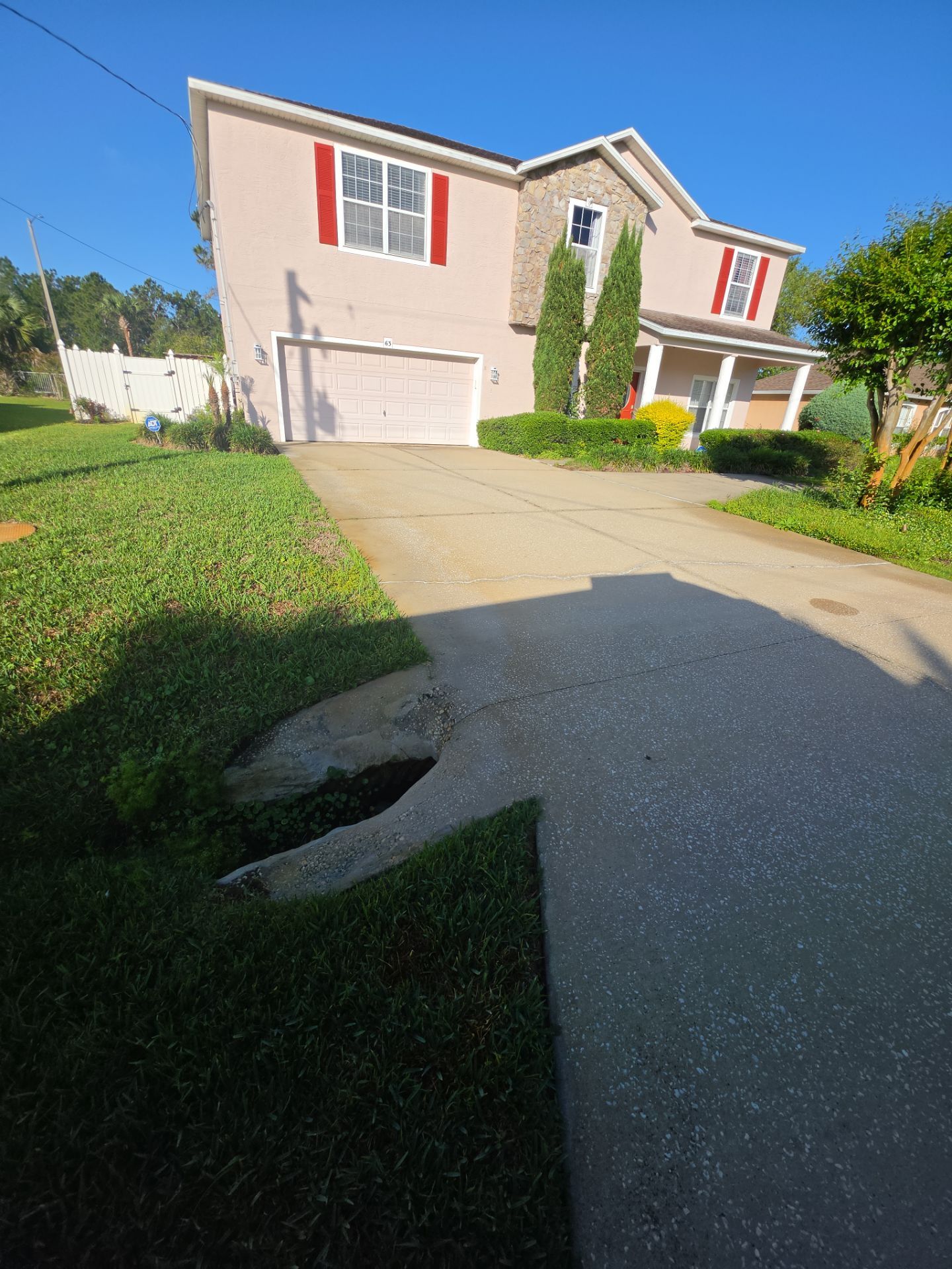 Stained, spalling concrete driveway before resurfacing