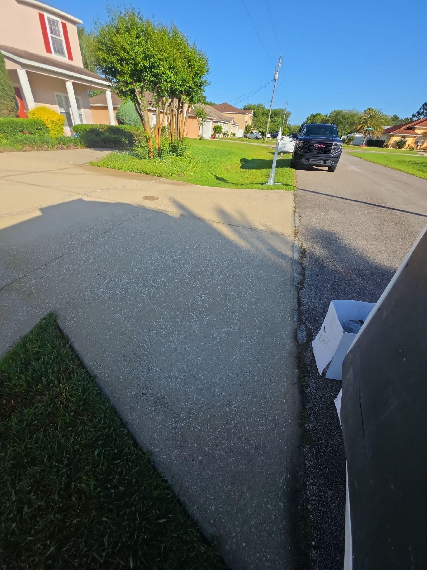 Driveway edge with moss and spalling before coating